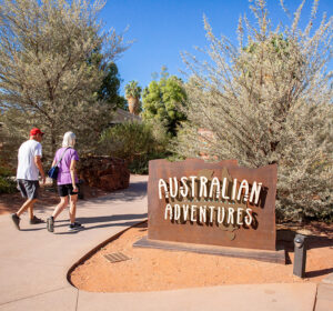 australian adventures sign with two guest walking by